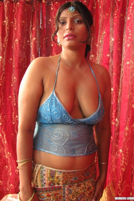 Пухленькая индианка обнажает свои натуральные сиськи и бритую киску на кровати 5