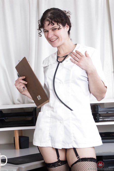 Зрелая брюнетка Саншайн сбрасывает докторскую одежду, прежде чем обнажить волосатую пизду 1