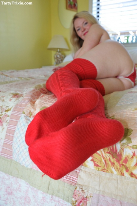 Зрелая неопытная аппетитная Трикси снимает лифчик и трусики в красных чулках 4