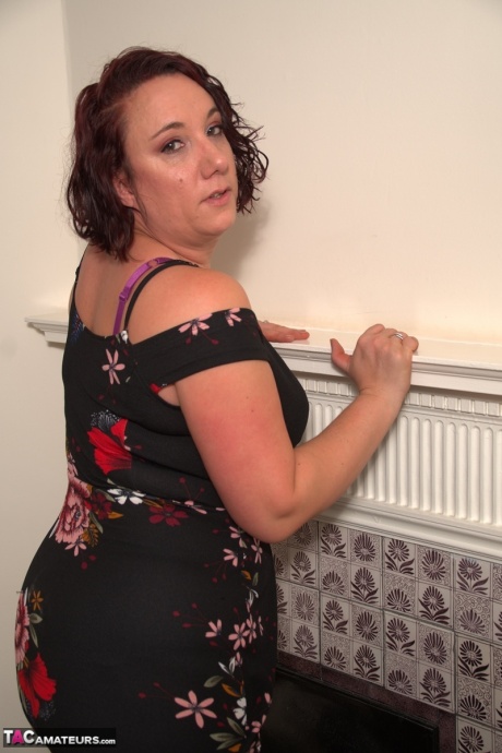 Зрелая леди сбрасывает свое платье, чтобы позировать в нижнем белье и нейлоновых чулках